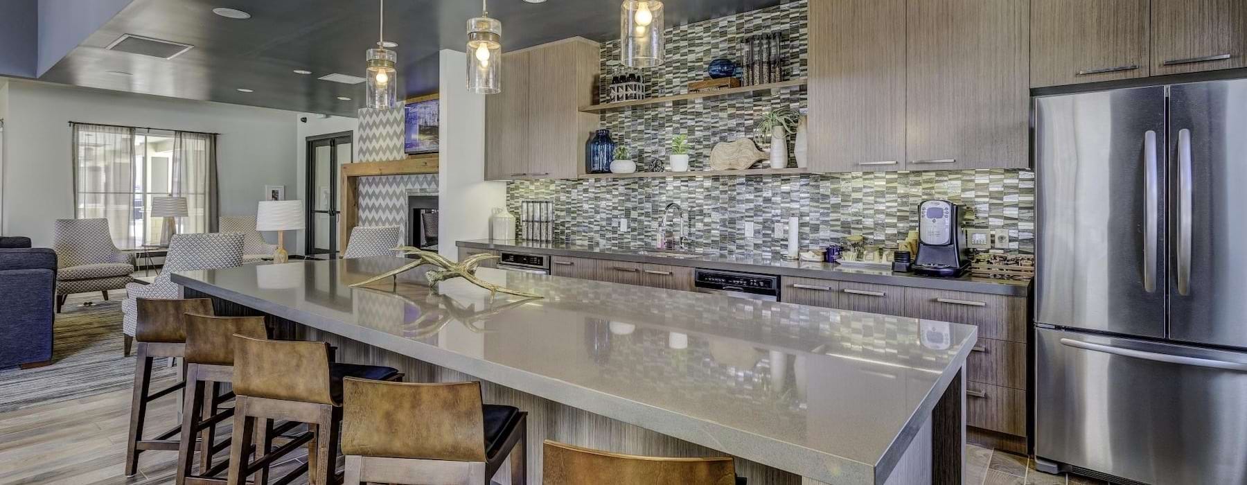 a kitchen with and island and chairs