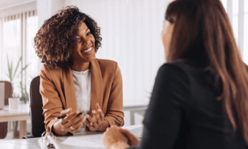 two women talking and smiling