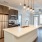 kitchen area on wooden floor with spacious counter-space and designer appliances